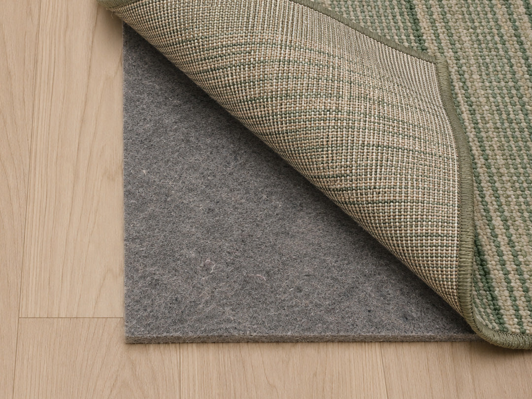 Ultimate all-surface rug pad under an area rug on a hardwood floor,