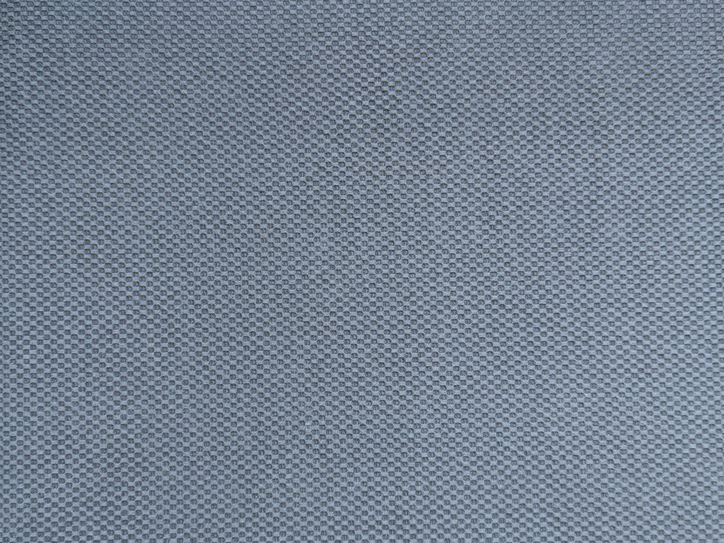 Embossed non-skid rubber backing of the ultra-thin rug pad