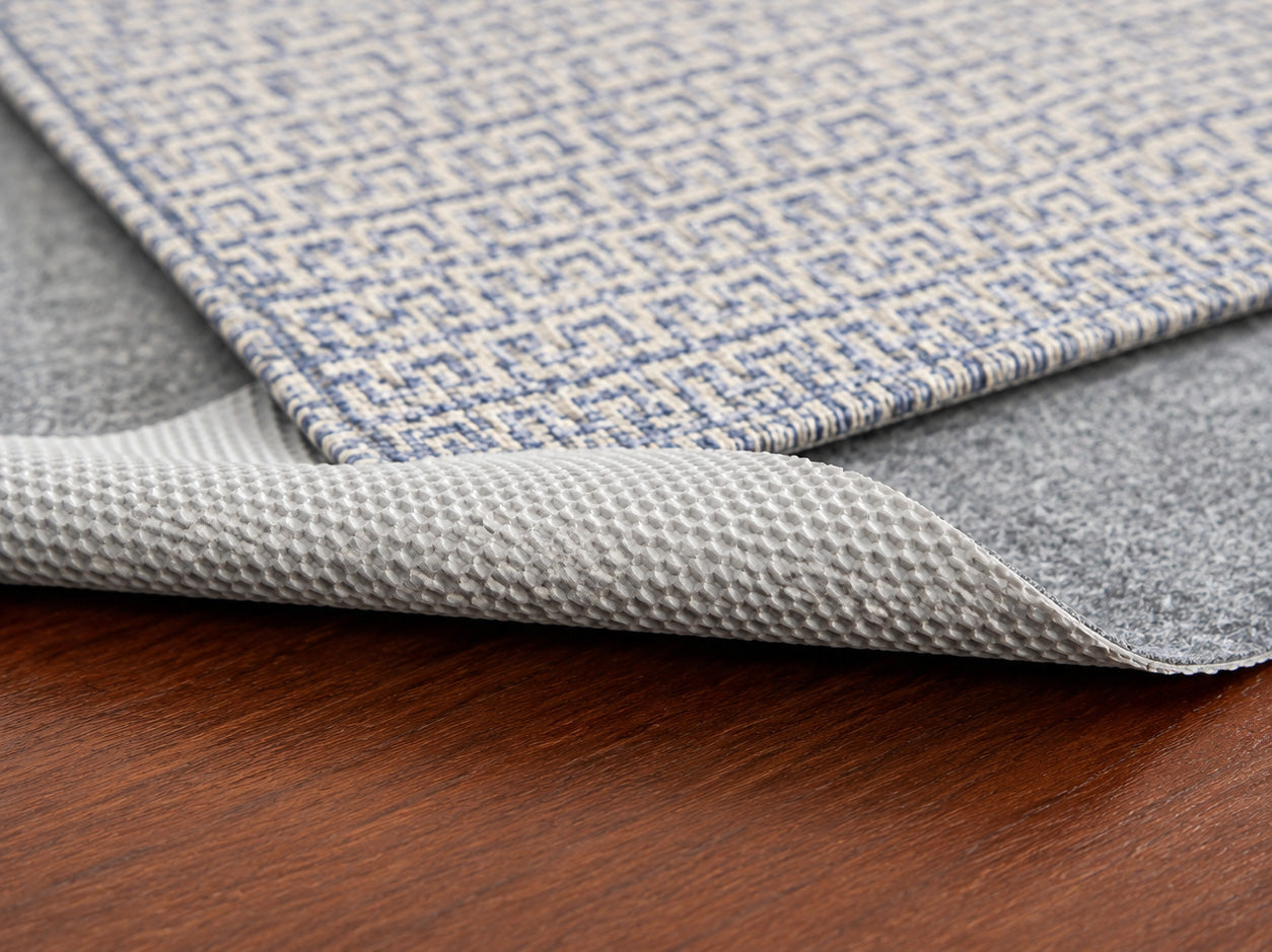 rug + pad on hardwood, folded corner)